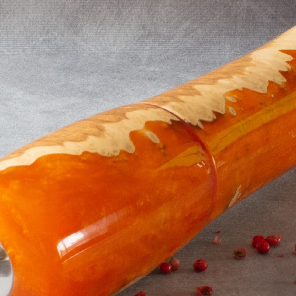 Close up texture of Red Mallee Burr grain meeting vibrant orange resin