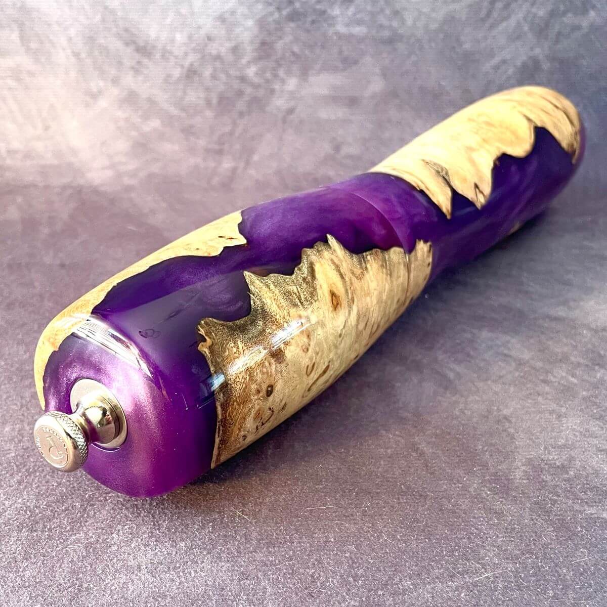 Top view of close up of purple resin and mappa pepper grinder showing adjustment knob