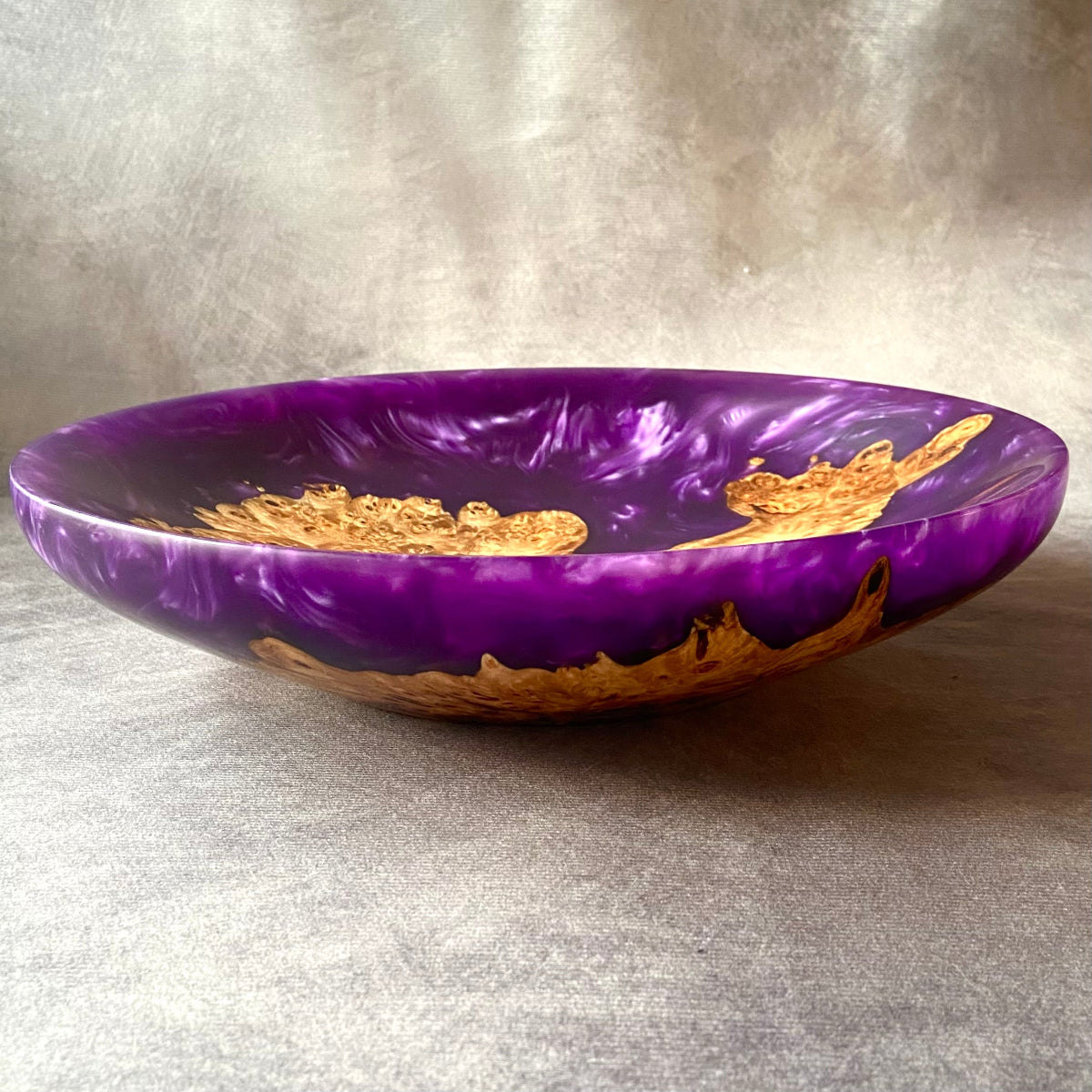 Side view of handmade purple resin and mappa burr bowl – unique turned wood and epoxy art piece with deep violet tones and organic burl details.