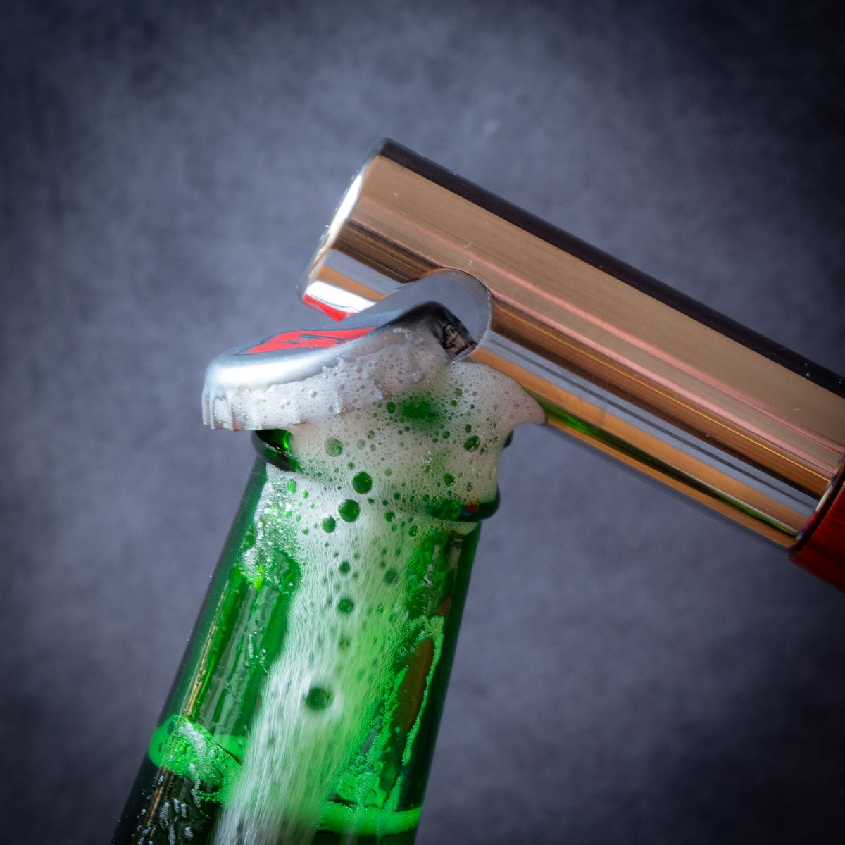 Beer bottle being opened with bottle opener