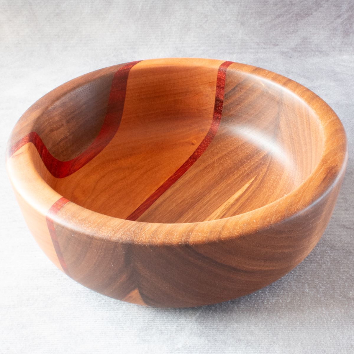 Wooden salad bowl in walnut padauk and cherry top view