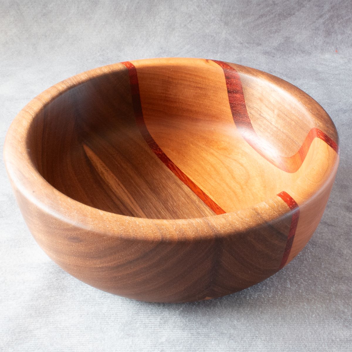 Wooden salad bowl in walnut padauk and cherry top view