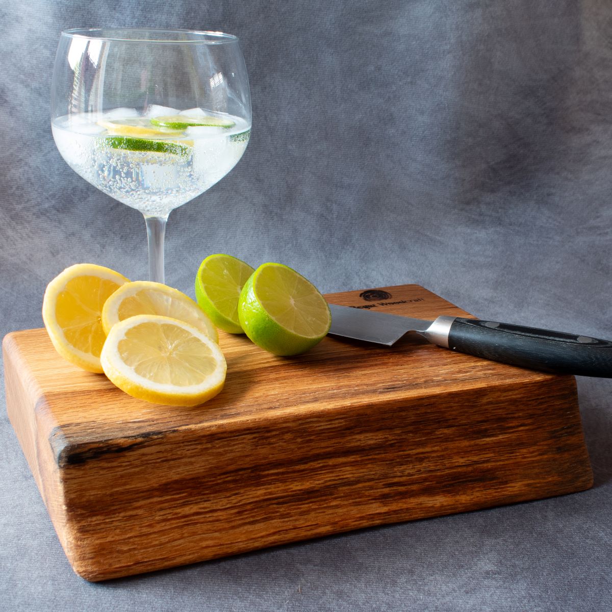 Natural edge English Oak cocktail board with limes and lemons