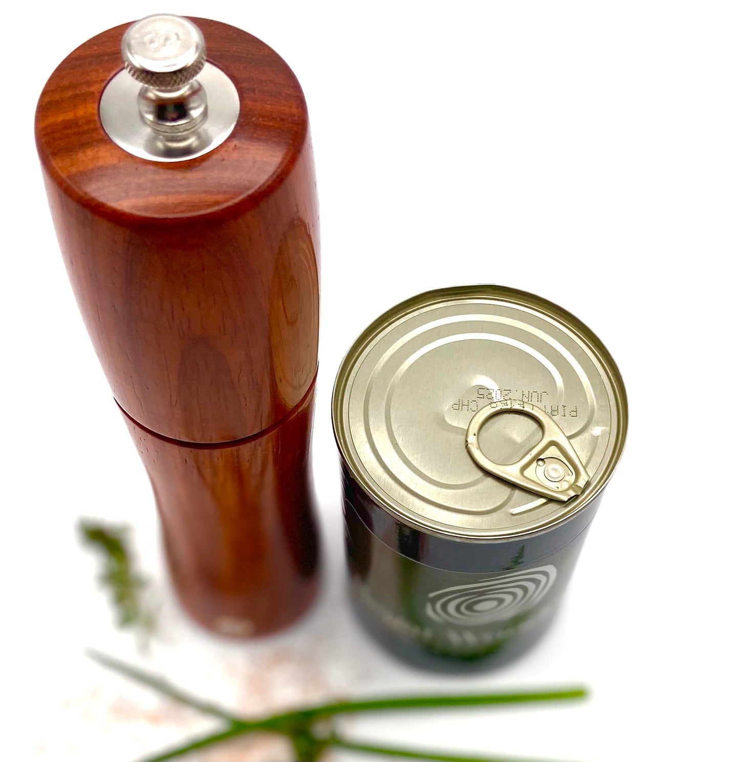 Top view of padauk salt mill pictured next to food tin to show height