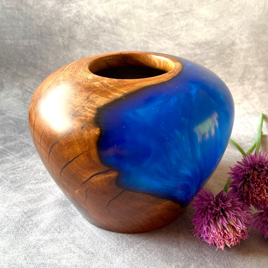 English apple wood and cobalt blue hollow form pictured with chive flowers