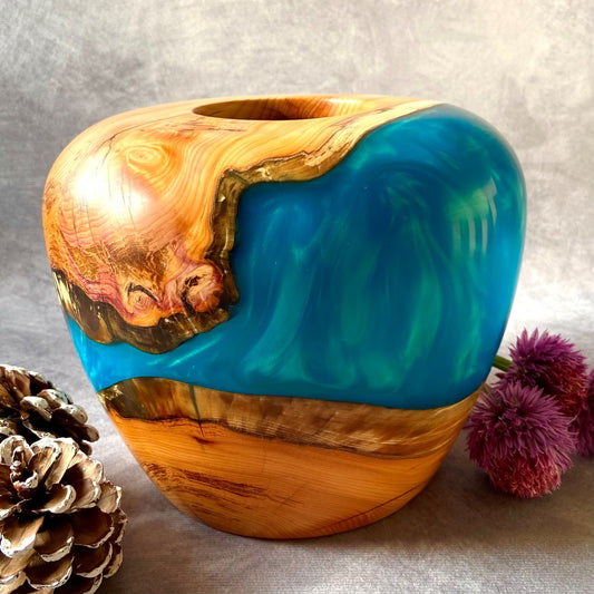 English yew and turquoise resin hollow form pictured with chive flowers