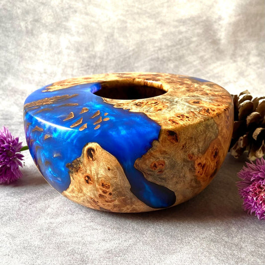 Cobalt blue and mappa burr hollow form pictured with chive flowers