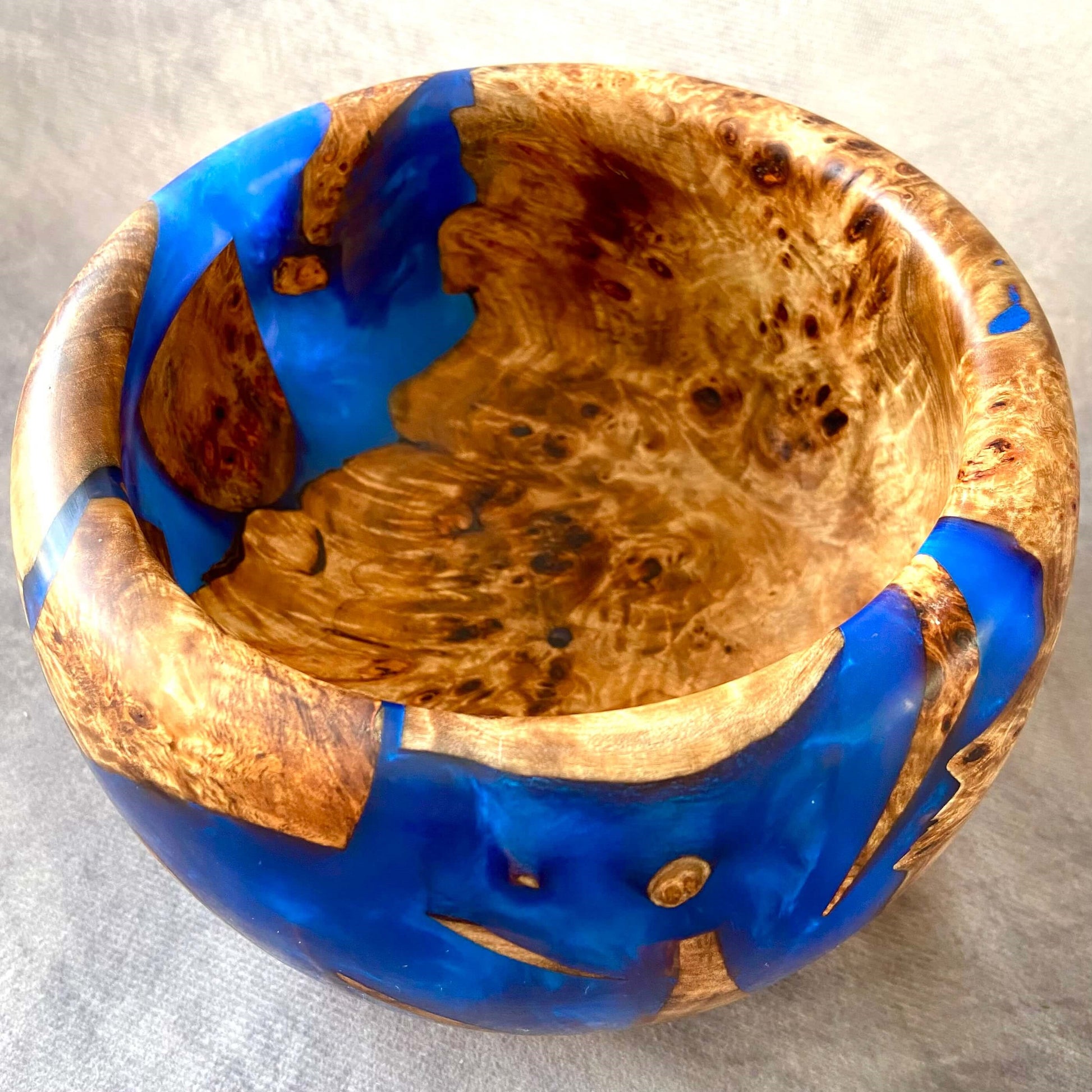 Top down view inside handmade Mappa Burr and Cobalt Blue resin bowl showing 110mm depth and natural grain patterns