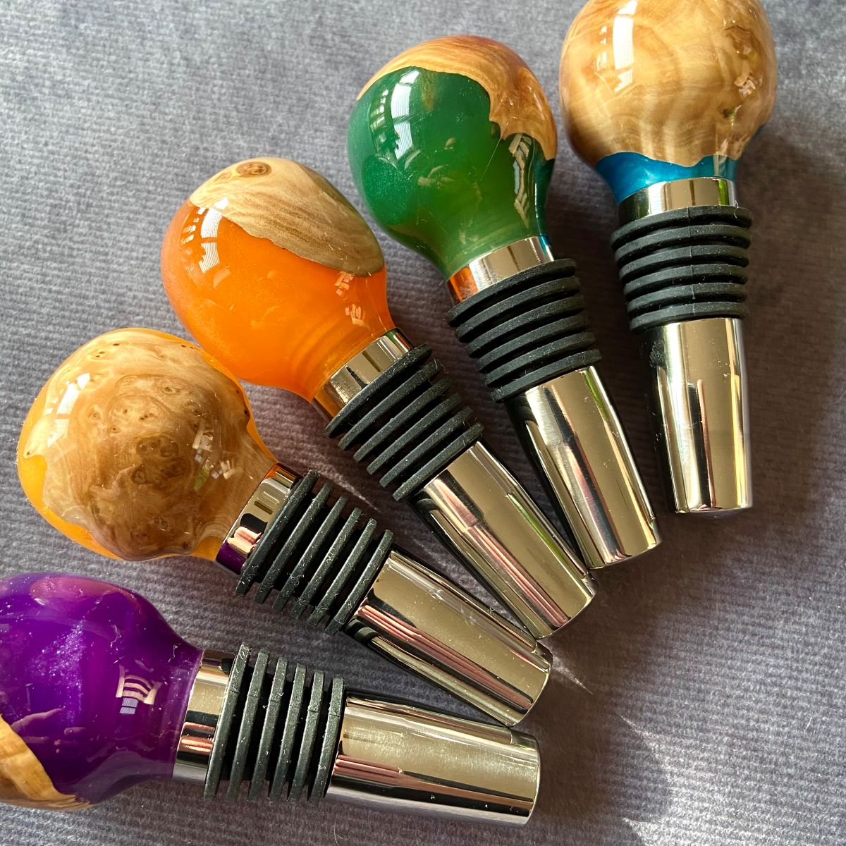Group view of mallee burr and resin wine stoppers showing colours