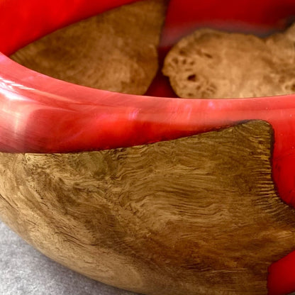 Close up detail of English Burr Oak grain meeting glossy scarlet red resin