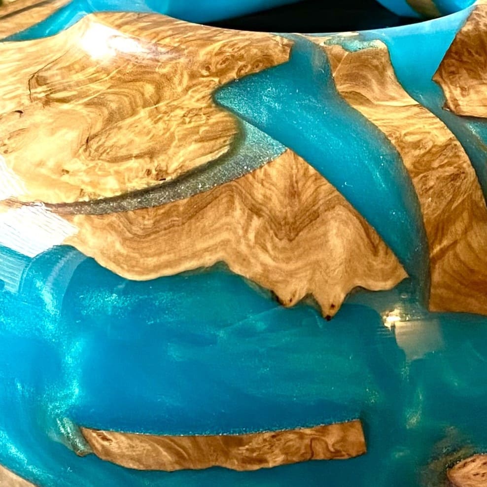 Close up texture of Mallee Burr offcuts embedded in jewel tone turquoise resin