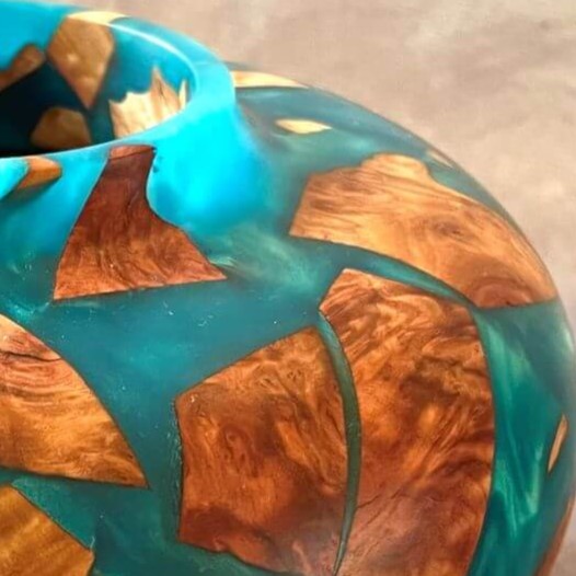 Close up detail of natural grain and turquoise resin on hollow form