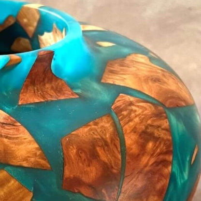 Close up detail of natural grain and turquoise resin on hollow form