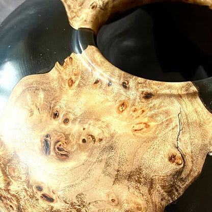 Close up texture of intricate Mappa Burr grain meeting deep black resin