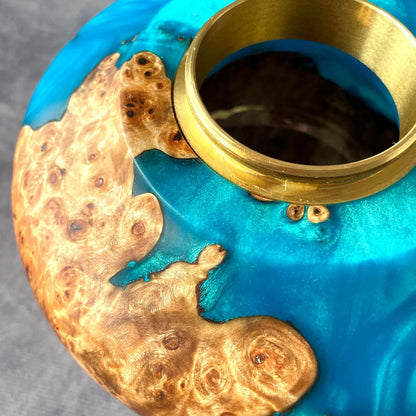 Close up detail of natural grain and turquoise resin on artisan pet memorial.