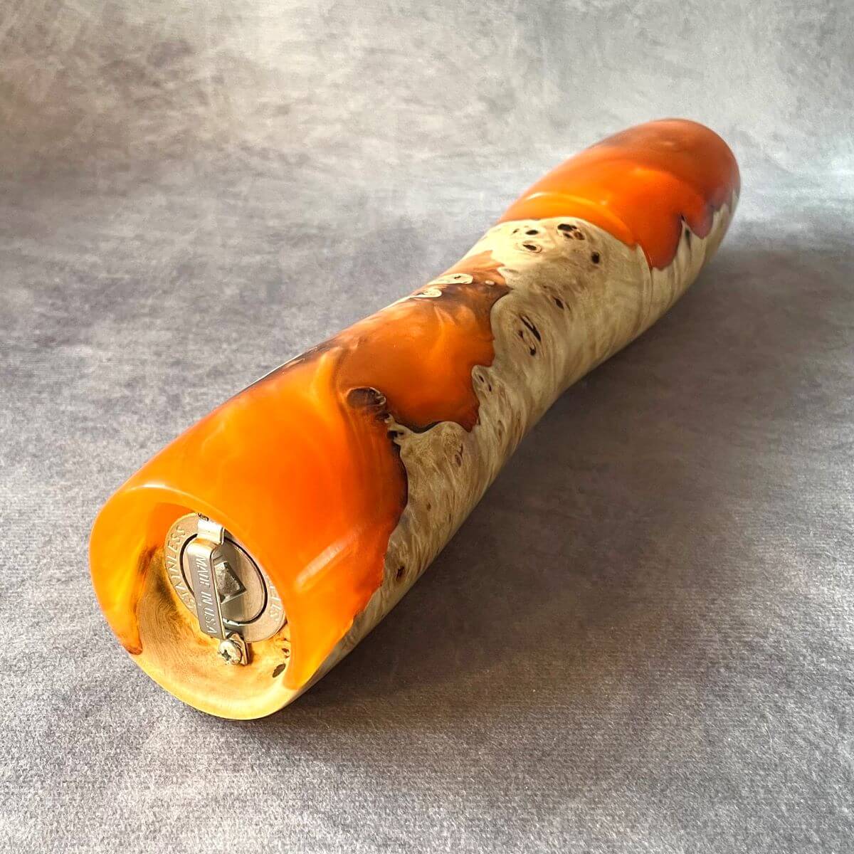 Side view of Mappa Burr and orange resin pepper mill showing grinding mechanism