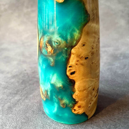 Close up macro detail of wild Mappa burr knots and turquoise resin high-gloss finish.