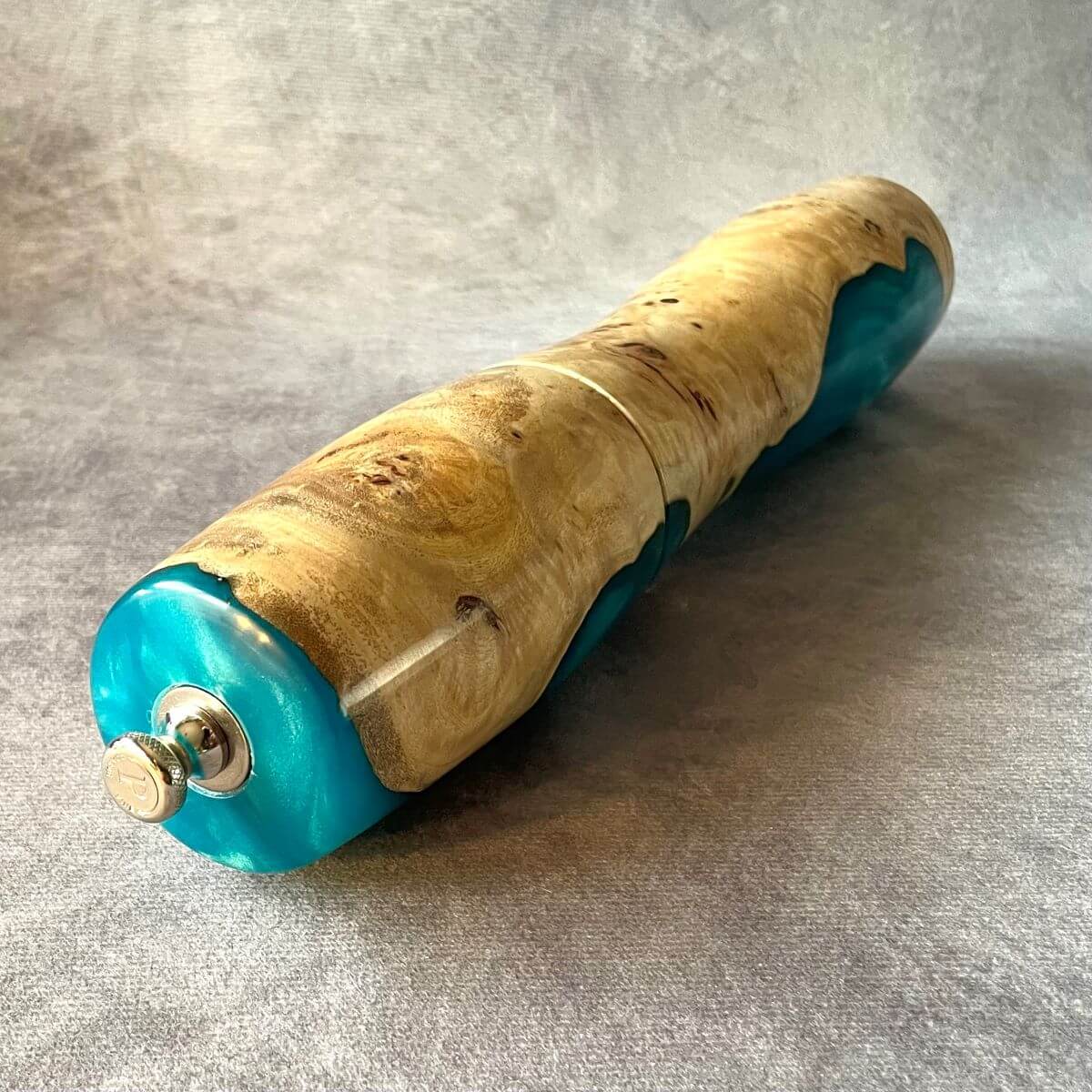 Close up detail of clustered grain and high-gloss finish on Mappa Burr and turquoise resin pepper mill.