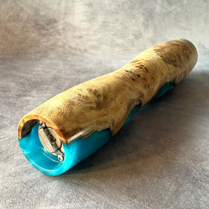 Side view of Mappa Burr and turquoise resin pepper mill showing turning curve and base.