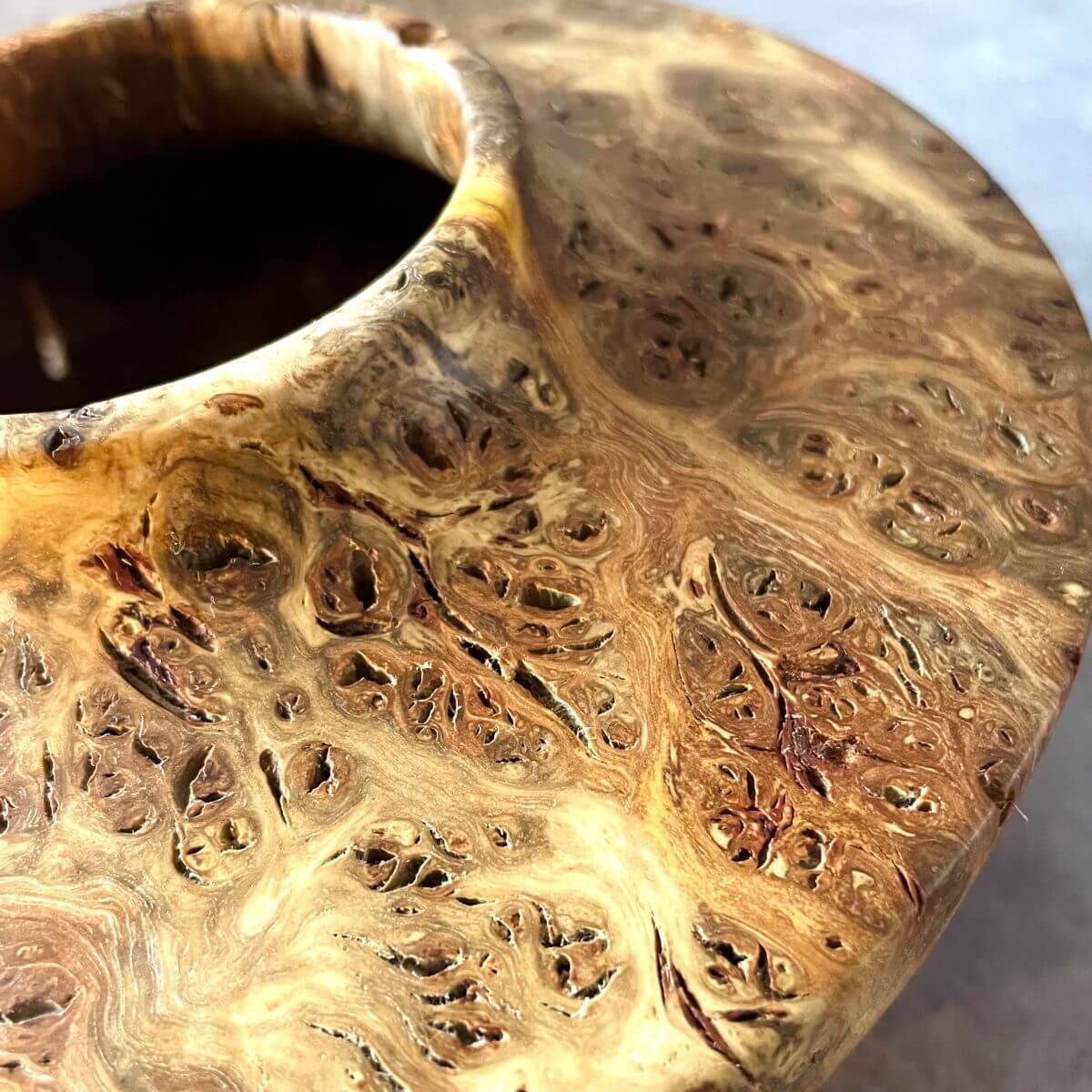 Close up detail of the natural clustered grain on a twice-turned mappa burr hollow form.
