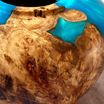 Close up texture of intricate Mappa Burr grain meeting shimmering turquoise resin