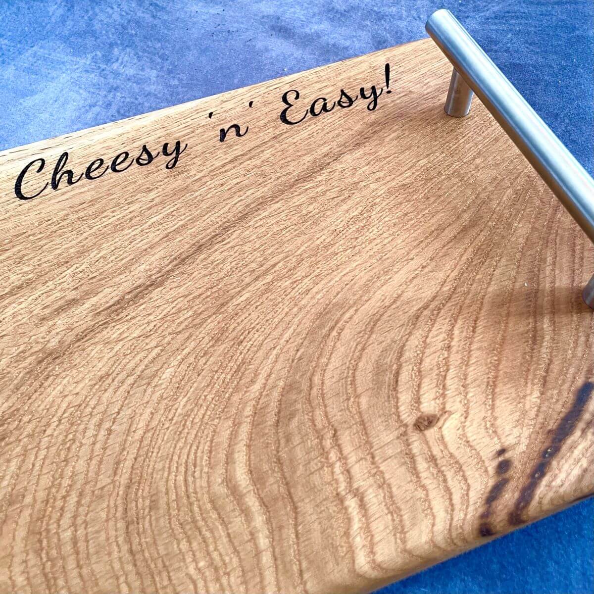 Close-up detail of the top right corner showing deep laser etched names and date. A traditional 5th wedding anniversary gift made from solid wood.