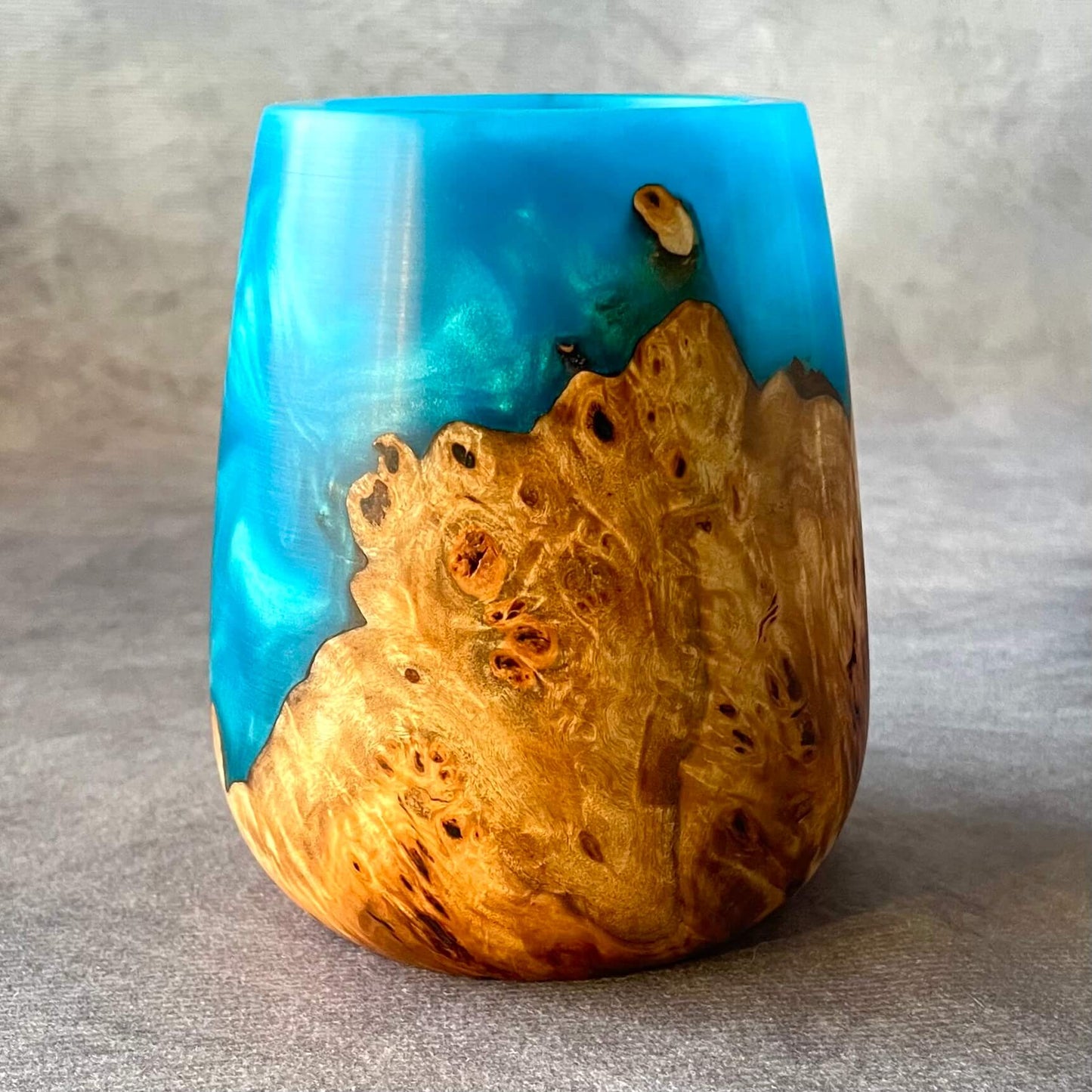 view of turned wood vessel showing the hollowed centre and artistic resin distribution.