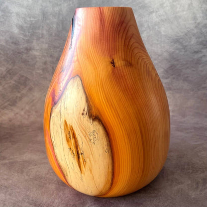 English yew hollow form showcasing rich orange and red grain. A unique sculptured vessel