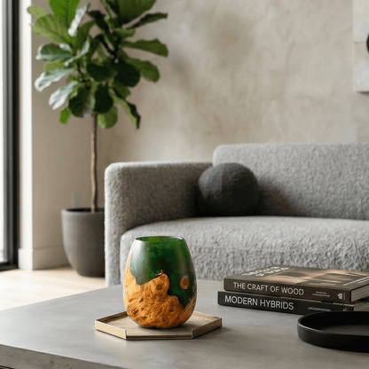 Decorative vase on a table with a couch and plant in the background