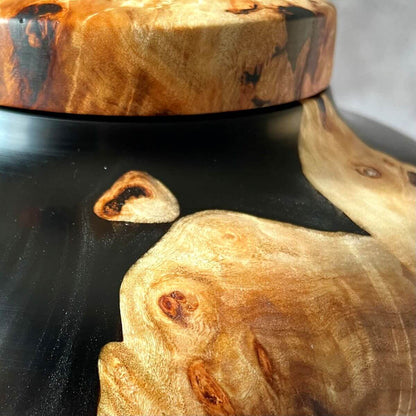 Close up of wood turned pet urns showing beautiful burr grain structure