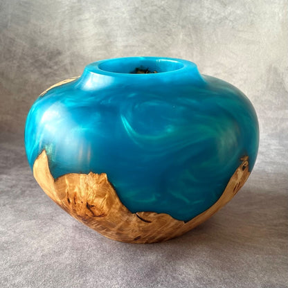 Side view of handmade wooden art showing curve and resin contrast.