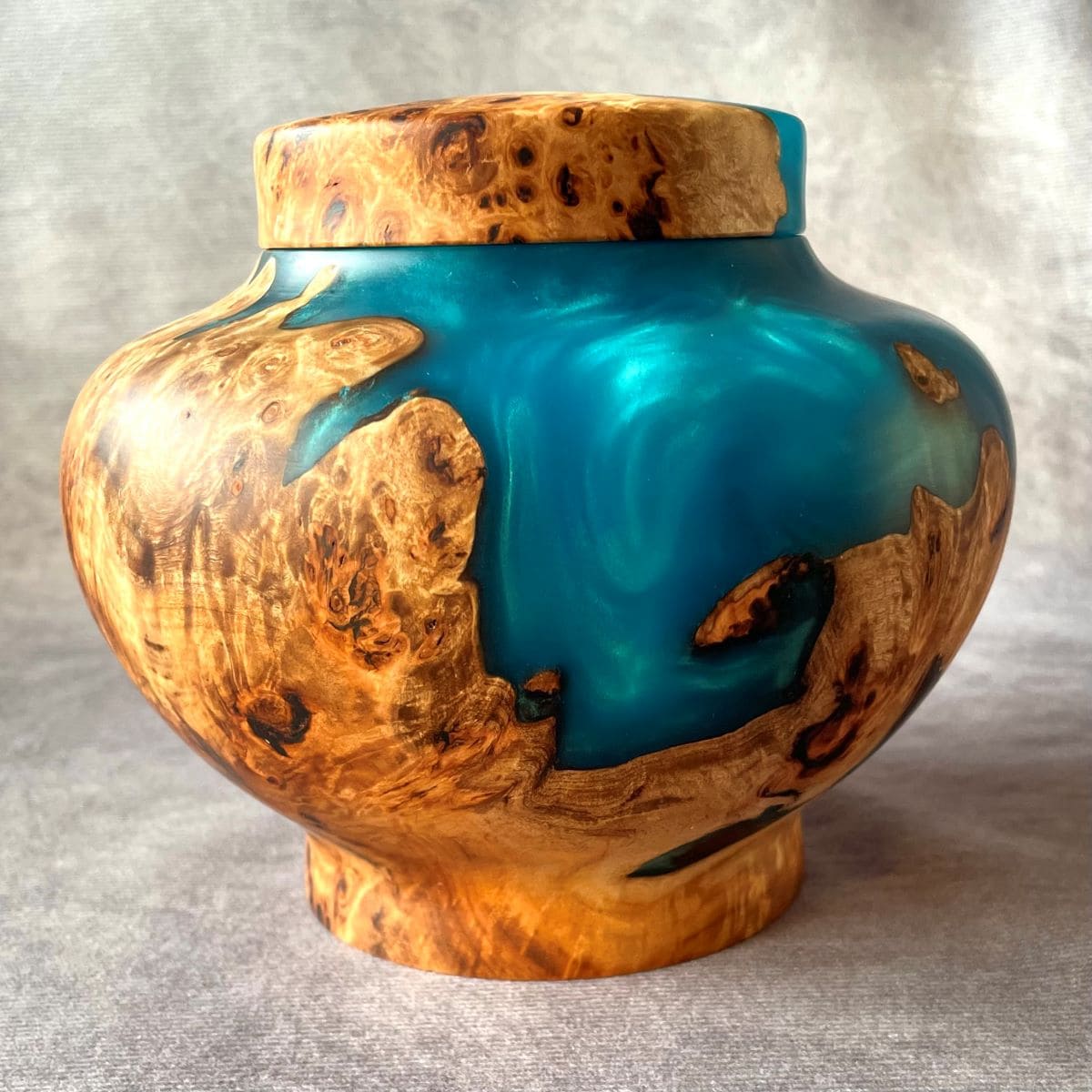 Handmade mappa burr and turquoise resin pet urn front view made in the UK.