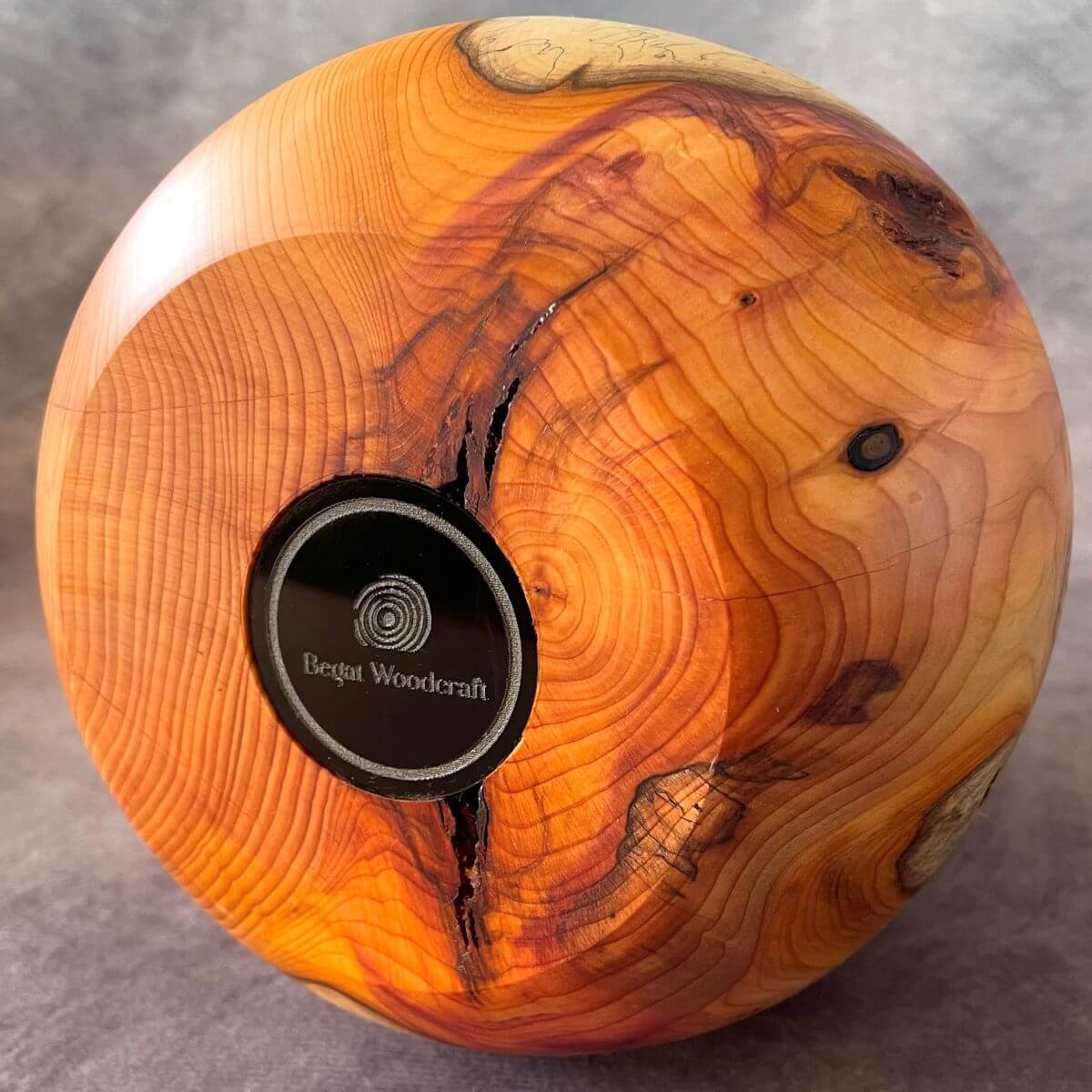 Close up of natural fracture on the base of English Yew decorative vessel. Authentic handmade wooden art  crafted in the UK.