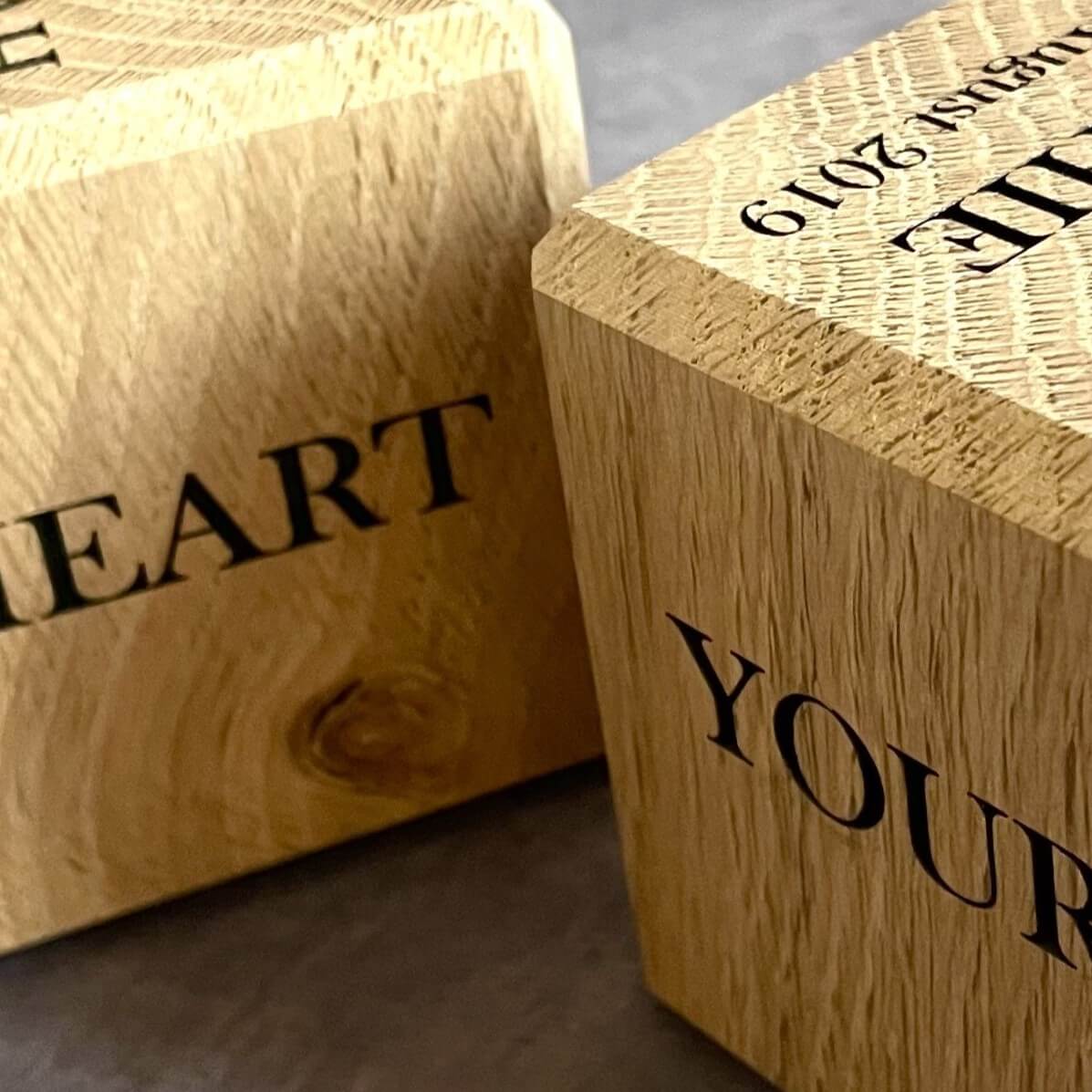 Close up detail of laser engraving and wood grain on Oak Cube.