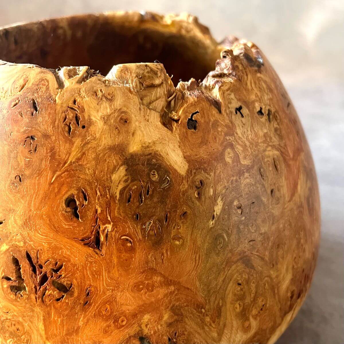 Close up detail of the natural clustered grain on a twice-turned mappa burr art vessel.