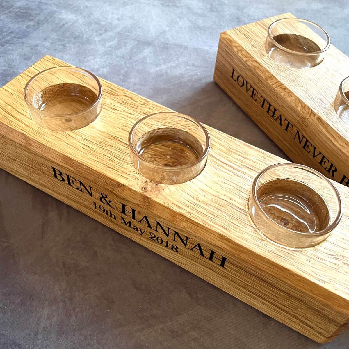 Close up of deep laser engraving of names and date on English Oak candle holder