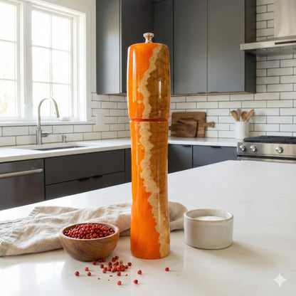 Large luxury orange and wood pepper mill displayed on kitchen counter