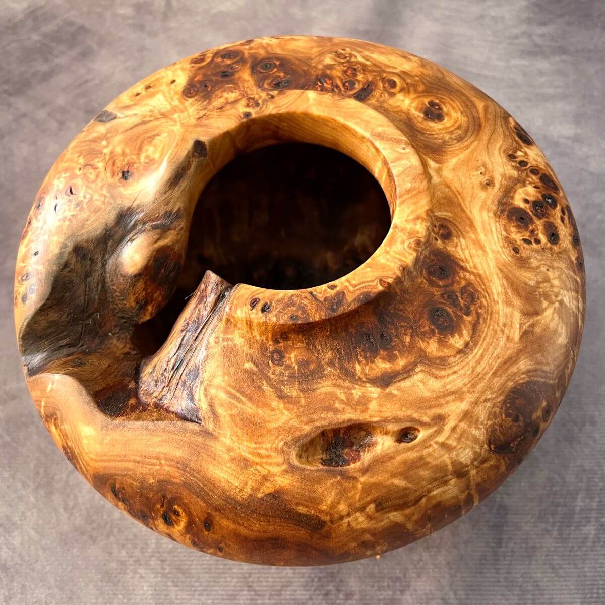 Top view showing the natural voids of this hand turned Mappa burl luxury wood sculpture.