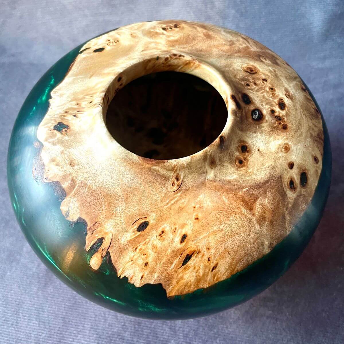 Overhead top view of turned art showing interior wood grain and resin blend.