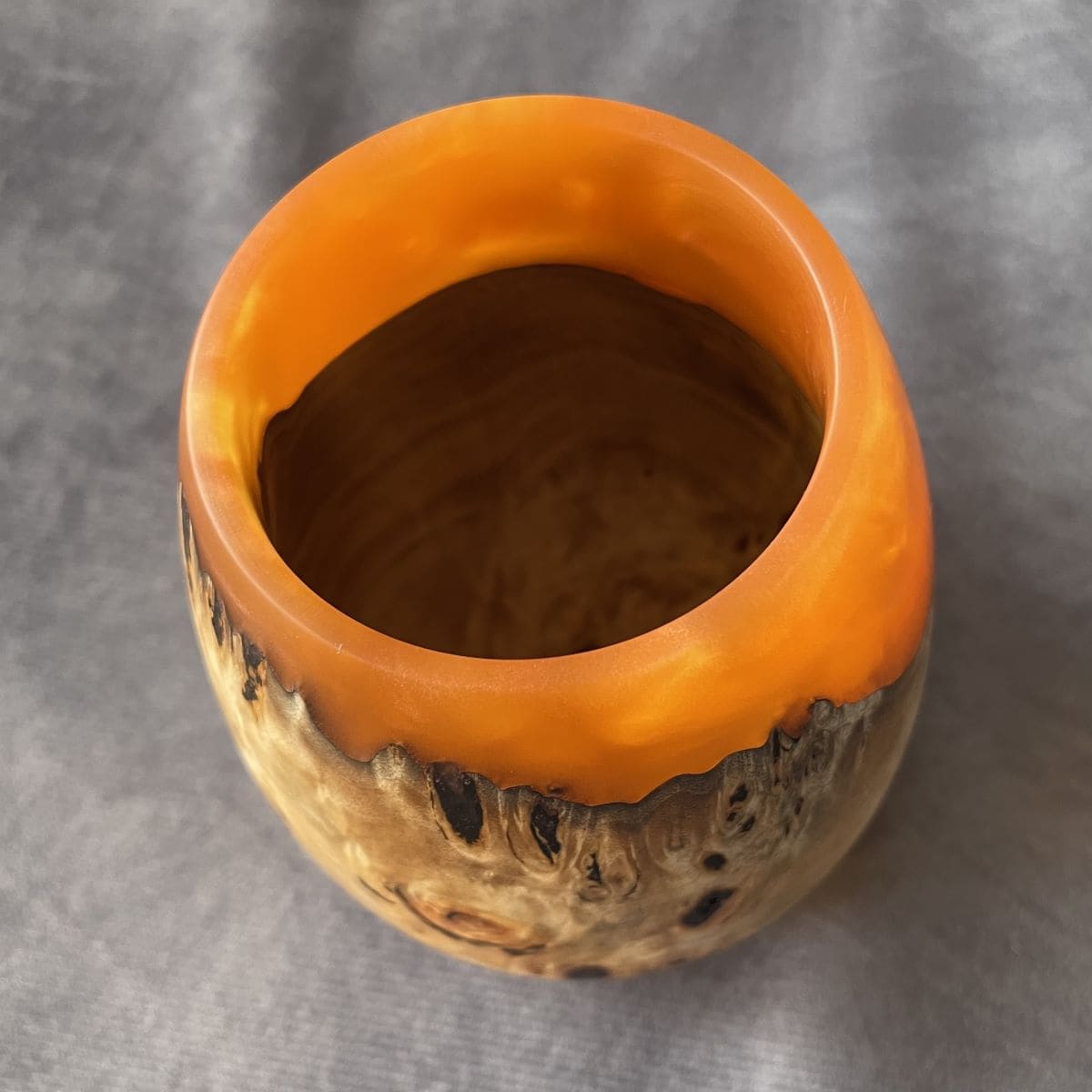 Overhead top view of turned art showing interior wood grain and resin blend.