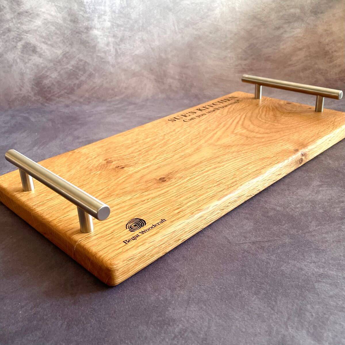 Large handmade English Oak charcuterie board featuring modern stainless steel handles. Shown with personalised laser engraving, perfect for a wedding or anniversary gift.