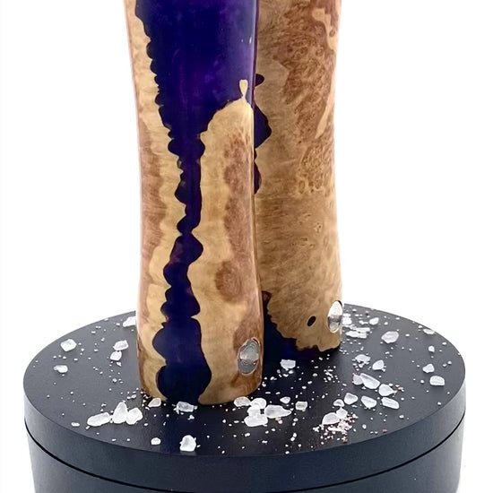 Video of salt and pepper shaker set in mallee burr with purple resin rotating on turntable