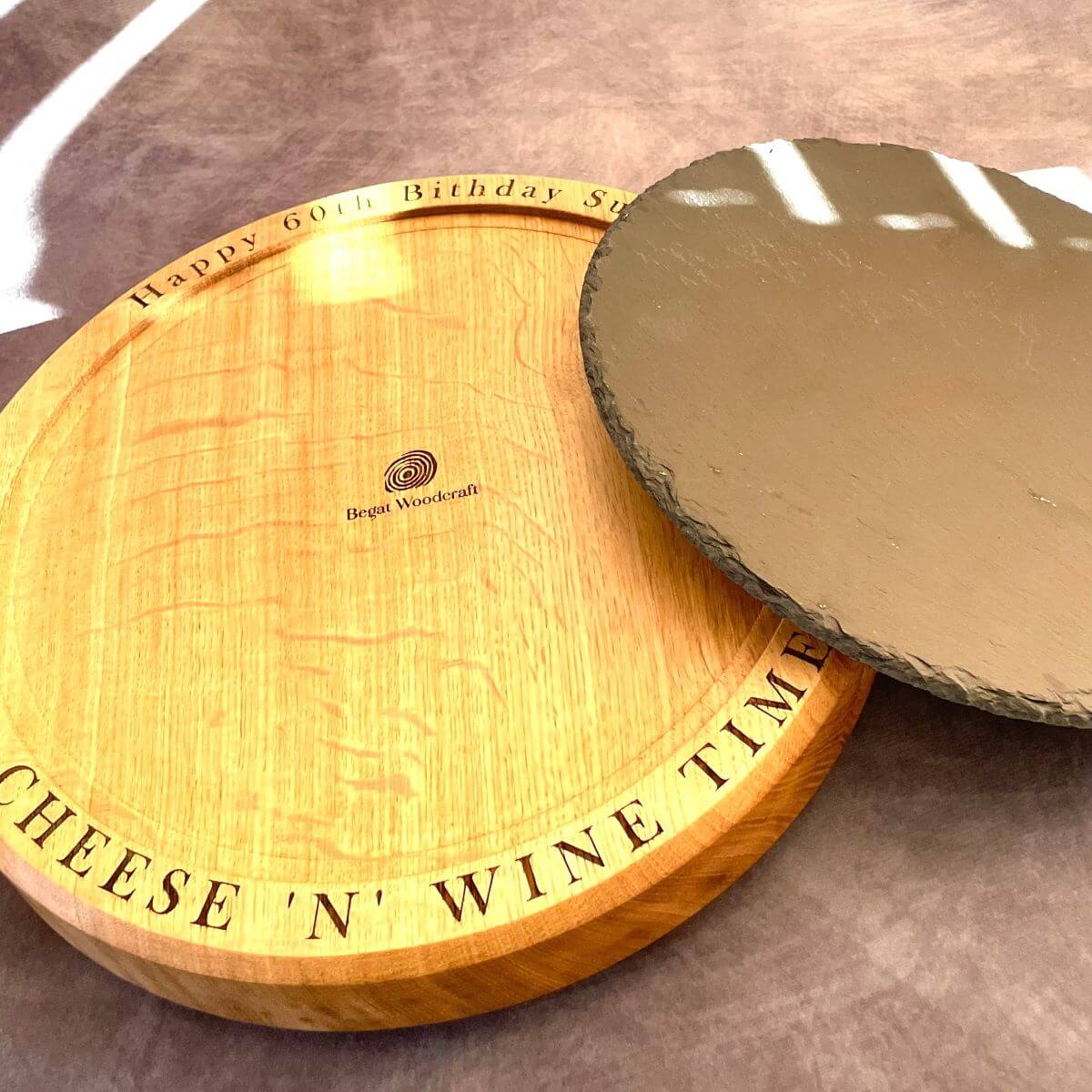 Wooden serving platter showing the removable slate insert for easy cleaning. 40mm thick solid oak profile.