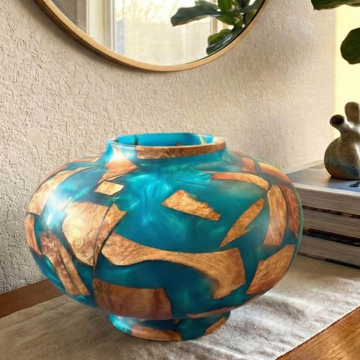 Turquoise resin and wood vessel displayed on top of cabinet