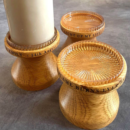 Solid English Oak pillar candle holder with candle, showing personalised laser engraving around the rim and glass insert.