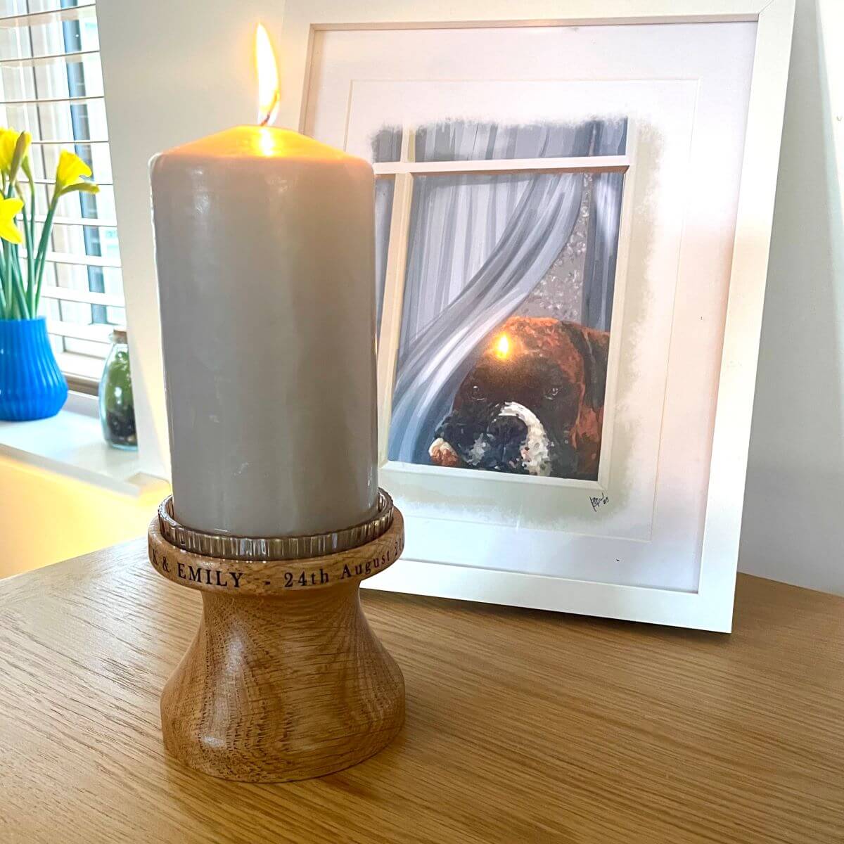 Solid English Oak pillar candle holder with lit candle, showing personalised laser engraving around the rim.