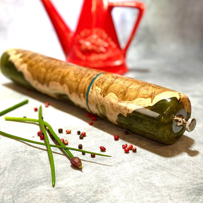 Close up detail of natural grain and high-gloss finish on Mallee Burr and green resin pepper mill.