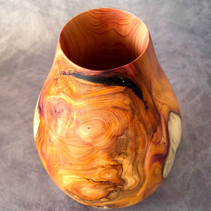 Top view of English yew hollow form showcasing rich orange and red grain. A unique sculptured vessel