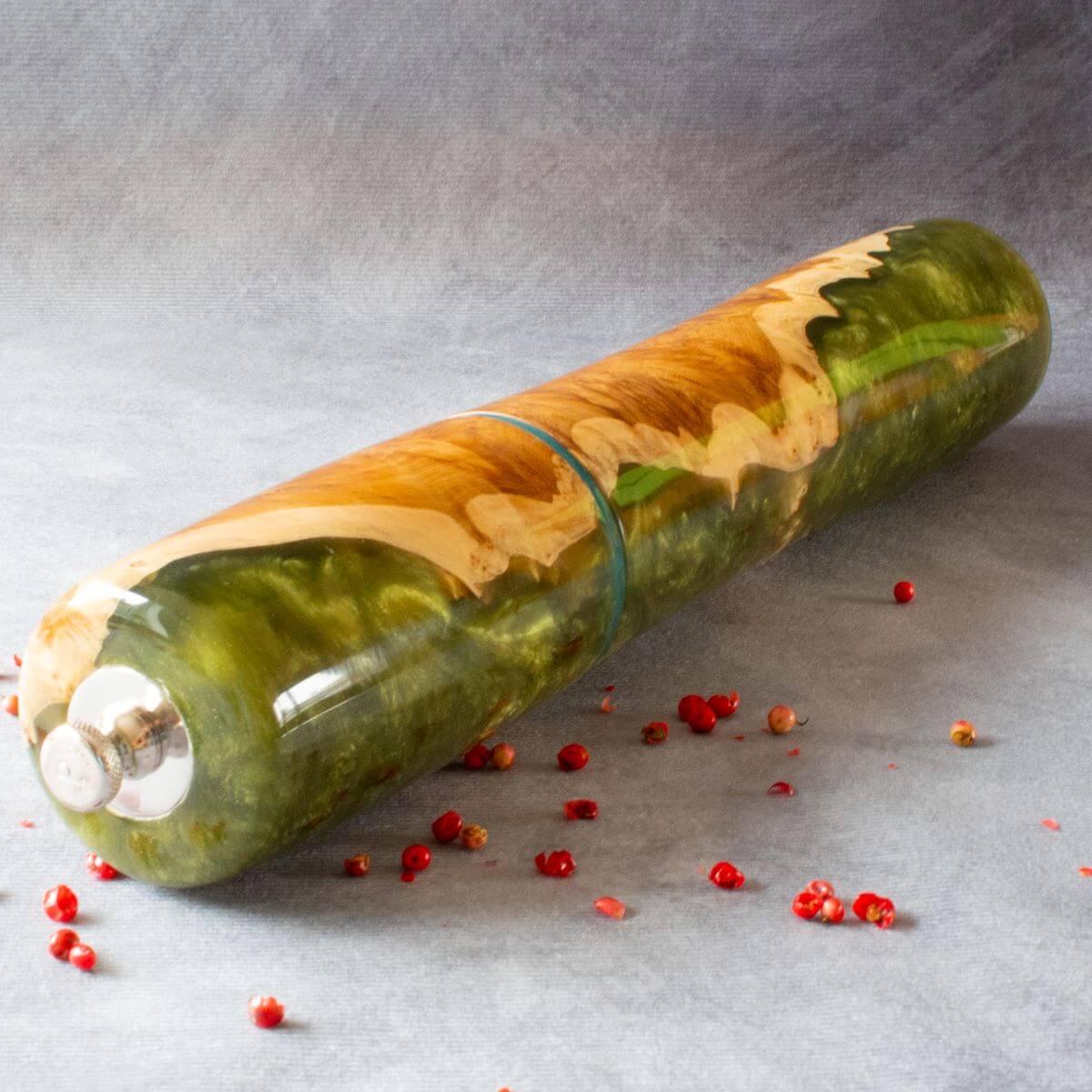 Side view of Mallee Burr and green resin pepper mill showing turning curve and base.
