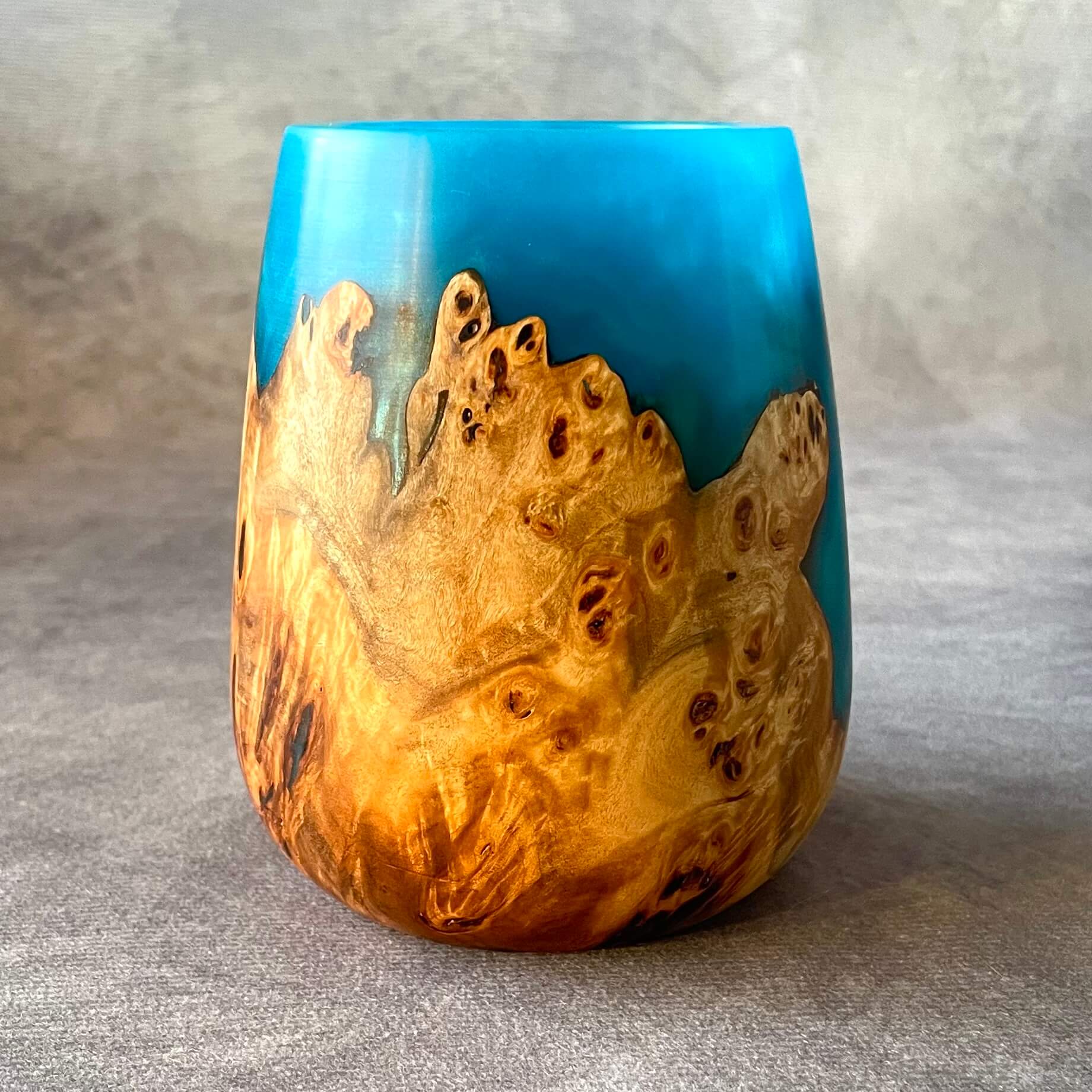 Natural grain and jewel tone turquoise resin on a mappa burr hollow form.